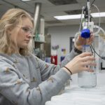 Photo of UWSP sophomore Lizzi Gizzi working on a project in the Water and Environmental Analysis Lab, where she has worked since her first year at UWSP.