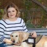 Photo of Randi Miranda, a U.S. Navy veteran and senior dietetics major, shown with her service dog, Abbey. They took part in a Veterans Day ceremony on Nov. 11 at UWSP.