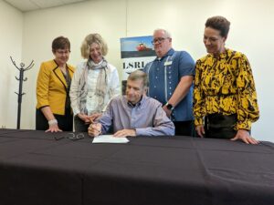 Photo of the University of Wisconsin–Superior’s Floating Classroom contract signing. The project is entering the construction phase. The plan for a floating classroom became a reality after a successful fundraising campaign conducted by the UW-Superior Foundation. From left, Jeanne Thompson, Vice Chancellor, University Advancement; Amy Eliot, LSRI Associate Director; Jim Tomczak, UW-Superior Foundation President; Matt TenEyck, LSRI Director; Renée Wachter, Chancellor. (Photo courtesy of UW-Superior)