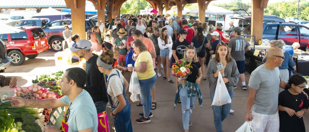 Photo of Eau Claire Farmers Market. A UW-Eau Claire research team working with the Eau Claire Downtown Farmers Market on a program that helps community members who are food insecure buy more fruits and vegetables. Dr. Eric Jamelske, professor of economics, leads the ongoing project, which has included dozens of Blugolds as researchers and/or volunteers. (Photo by Shane Opatz)