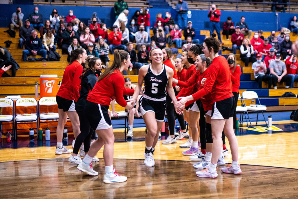 Photo of UWRF student-athlete Kameri Meredith, who is all smiles as she is introduced before a UW-River Falls women’s basketball game in the WIAC tournament on Feb. 21 at UW-Eau Claire. Sam Silver photo.