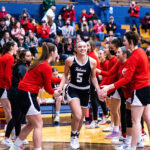 Photo of UWRF student-athlete Kameri Meredith, who is all smiles as she is introduced before a UW-River Falls women’s basketball game in the WIAC tournament on Feb. 21 at UW-Eau Claire. Sam Silver photo.