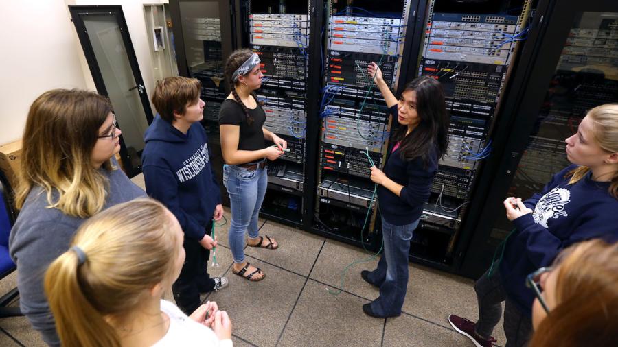 Photo of Professor Holly Yuan showing a computer server to a CNIT female student in Michaels Hall's lab. / UW-Stout