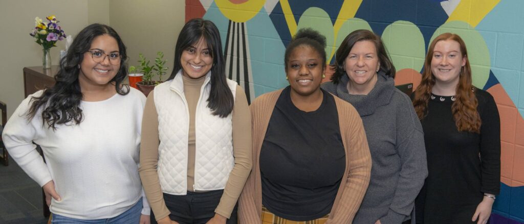 Photo of a fall 2022 team of UW-Eau Claire undergraduate and graduate students who helped the university’s Fostering Success program reach more current and future Blugolds who were in foster care or experienced homelessness as youth enroll and be successful in college. The Fostering Success leadership team includes, from left, students Molly Urmanski, Mia Johnson and Taz Smith, along with staff member Jodi Thesing-Ritter and graduate student Jessica Brooks. (Photo by Shane Opatz)