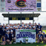 Photo of the UW-Eau Claire women’s rugby club team proudly displays the Division II National Champions pennant. (UW-Eau Claire)