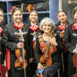 Photo of Dinorah Márquez Abadiano (center) posing with some of her students before a performance: Natali Rodriguez (from left), Zaara Bonilla, Lili Hernandez Dingel, Lucy Apolinar and Carolina Islas. (UWM Photo/Troye Fox)