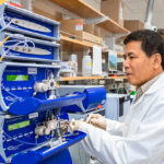 Photo of Laodong Guo, professor of freshwater sciences, investigating the molecular structures of microplastics to determine how small they ultimately become in waterways. (UWM Photo/Elora Hennessey)