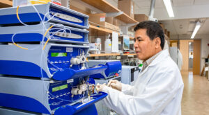 Photo of Laodong Guo, professor of freshwater sciences, investigating the molecular structures of microplastics to determine how small they ultimately become in waterways. (UWM Photo/Elora Hennessey)