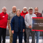 Photo of ceremony: The upper level of UWRF's Falcon Center, through which nearly all Falcon fans pass to attend home basketball and hockey games, will now be known as the James and Margery Belisle Concourse, following the 1954 graduates' $250,000 gift to the UW-River Falls Foundation. The couple wasn't able to attend the dedication ceremony but the Belisles' nephews and niece represented the family. From left: UWRF Assistant Chancellor for University Advancement Rick Foy and family members Craig, Jean, Lynn, Keith and Rich Geurkink.
