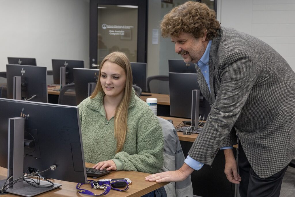 Photo of Natasja Iversen, Oshkosh, who liked problem-solving games and math. The senior, pictured with Kurt Pflughoeft, director of the UWSP Center for Data Analytics, is majoring in data analytics for a high-demand career and great return on her educational investment.