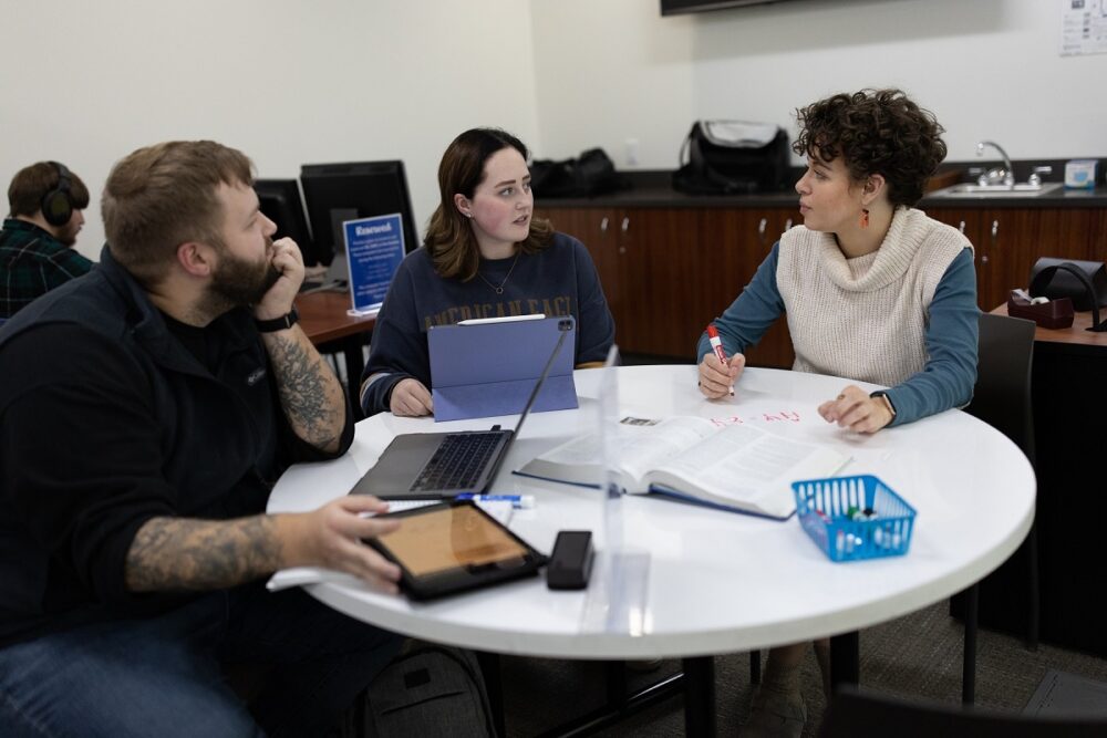 Photo of Chloe Gulbronson (right), who served as a tutor for chemistry, biology, physics and math and also mentored tutors while pursuing her degree at UW-Stevens Point. Here, she’s with students Mitchell Imlan and Josie Voigt in the Chemistry Biology Building drop-in tutoring lab.