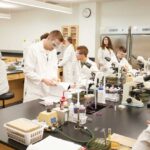 Photo of UWL graduates, particularly those in the sciences, who are critical to Kwik Trip's recruiting efforts in food safety and related fields. This talent pipeline would be strengthened, Kwik Trip leaders say, through the completion of UWL's Prairie Springs Science Center.