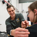Photo of Kevin Biese, assistant kinesiology professor and graduate student Abby Godejohn ’22, preparing to use motion capture markers in one of the rooms that make up the new Sport Performance and Injury Research Lab at UW Oshkosh.