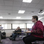 Photo of Wisconsin Poet Laureate Nick Gulig, left, leading a discussion with an advanced writing class on Monday, Jan. 23, 2023. (UW-Whitewater Photos/Craig Schreiner)