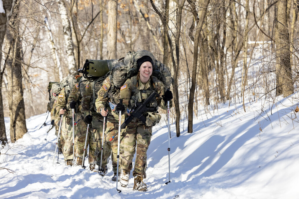 Photo of cadets who completed several challenges at Fort McCoy — rifle marksmanship, knot-tying, treatment of a hypothermic casualty and fire-starting — before ending with a 17-mile ruck march through La Crosse’s Hixon Forest trail system.