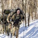 Photo of cadets who completed several challenges at Fort McCoy — rifle marksmanship, knot-tying, treatment of a hypothermic casualty and fire-starting — before ending with a 17-mile ruck march through La Crosse’s Hixon Forest trail system.