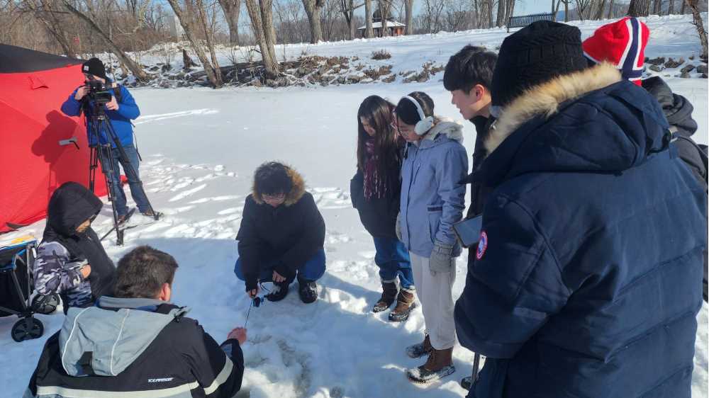 Photo of UW-La Crosse international students who joined campus police and others for a day of ice fishing at Pettibone Park. The second-annual event was started as a way to build mutual trust and understanding, and to introduce international students to the Wisconsin wintertime tradition.