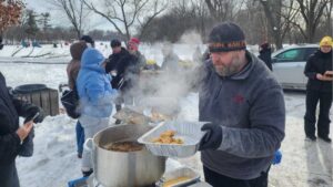 Photo of Senior Executive Chef Robb Hanson, from the university’s food service, preparing a classic Wisconsin fish fry for those in attendance.