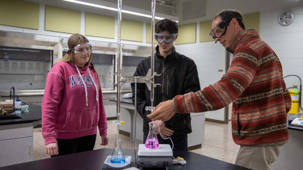 Photo of Dr. Stephen Swallen, professor of chemistry, working with students.