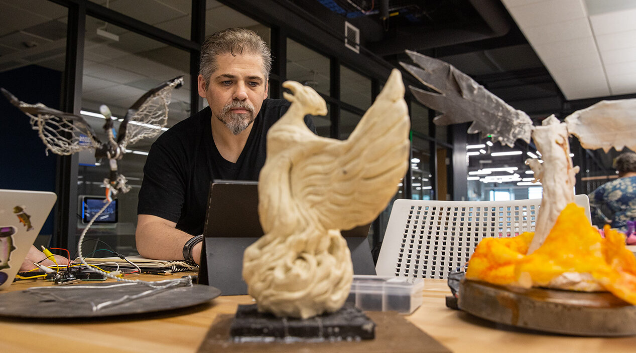 Photo of UW-Platteville student and professional illustrator Jacob Muller uses the university’s technology in the new Huff Family Innovation Center to turn his favorite drawing subject, the mythological phoenix, into three-dimensional sculptures in different mediums. (Photo credit: UW-Platteville)