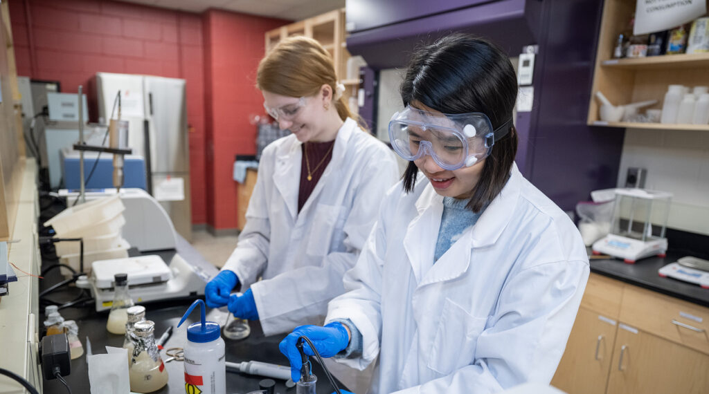 Photo of UW-River Falls students Sierra Kolodjski, left, and Yihong Deng conducting work on their Research in the Rotunda project. The duo seeks to develop a more resistant biodegradable packaging film that could be used instead of plastic on a mass scale.