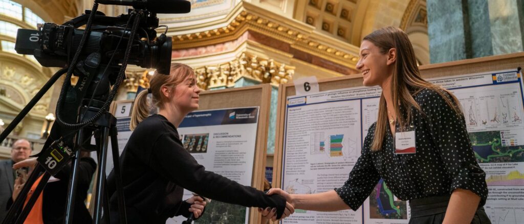 Photo of Marchiafava shaking hands with Madison media reporter.