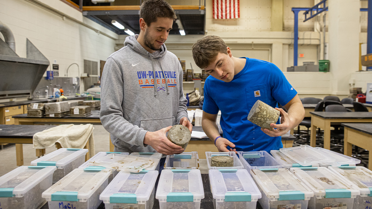 Photo of Dylan Notsch and Will Straka (left to right) studying the effects of anti-icing on concrete.