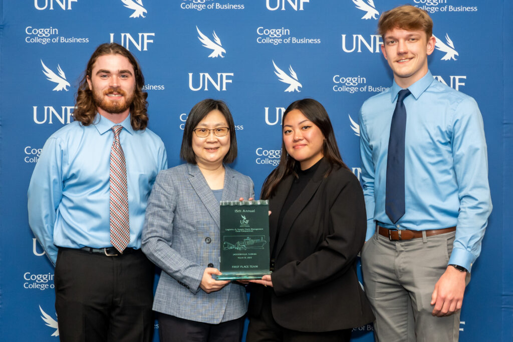 Photo of the team of University of Wisconsin-Superior transportation and logistics management and supply chain management students, which included Matt Thompson, Laura Kumimatsu and Kallahan Kappes, and coached by Mei Cao (second from left), who earned first place in the annual UNF Logistics & Supply Chain Management Case Competition. (Photo courtesy of University of Wisconsin-Superior)