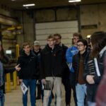 Photo of Paul Bagniefski, far left, president of Mid-City Steel, leading UW-La Crosse accountancy students on a tour of the company's manufacturing facilities. This spring, students are gaining real-world accounting experience through a partnership with Mid-City Steel — part of UWL's Community Engaged Learning program.