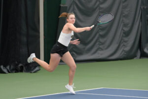 Photo of Konieva playing tennis. She has put together a solid record as a freshman this season, playing both singles and doubles. (Len Cederholm/for Milwaukee Athletics)