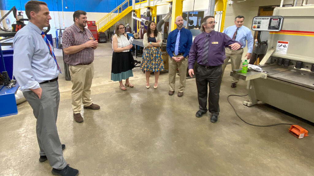 Photo of UW-Platteville officials touring Nicolet College labs and classrooms during their visit and signing ceremony that opens the door for Northwoods residents to earn engineering bachelor’s degrees. Academic leaders from both institutions are pictured here in Nicolet’s metal fabrication lab.