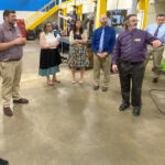 Photo of UW-Platteville officials touring Nicolet College labs and classrooms during their visit and signing ceremony that opens the door for Northwoods residents to earn engineering bachelor’s degrees. Academic leaders from both institutions are pictured here in Nicolet’s metal fabrication lab.