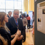 Photo of UW System President Jay Rothman conversing with UW-River Falls students Lauren Loock, center, and Linnea Milner Thursday as they presented their work during the National Conference of Undergraduate Research at UW-Eau Claire. Bill Hoepner photo.