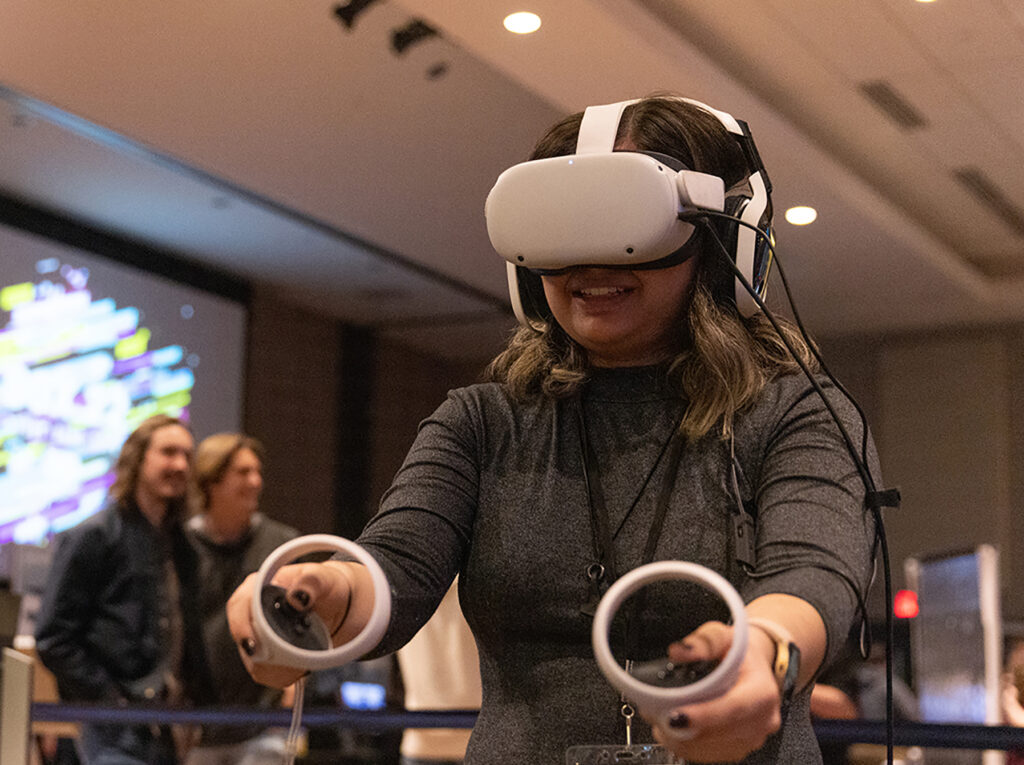 Photo of a student trying a virtual reality game during a recent Stout Game Expo.