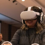 Photo of a student trying a virtual reality game during a recent Stout Game Expo.