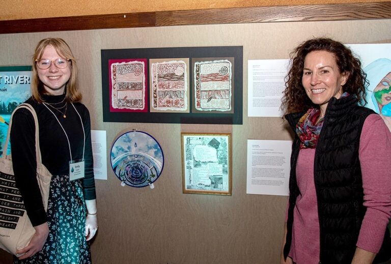 Photo of Emily Odegard (left) who created this block print of geologic layers after working with Samantha Kaplan, geography/geology professor at UW-Stevens Point. She is one of 31 student artists chosen for The Flow Project that is now on exhibit at the Portage County Library in Stevens Point.
