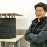 Photo of Chanyeop Park showing the inductor in his lab. It’s part of a research project he and Georgia Tech are working on to create a high-voltage circuit breaker that uses a much greener alternative to the gas currently used in high voltage electrical equipment. (UWM Photo/Troye Fox)