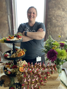 Photo of Brianne Rehak, owner of That Girl Brie grazing table, who said her business sales have increased significantly since she began using the St. Croix Valley Business Innovation Center’s food space three months ago. UWRF photo.