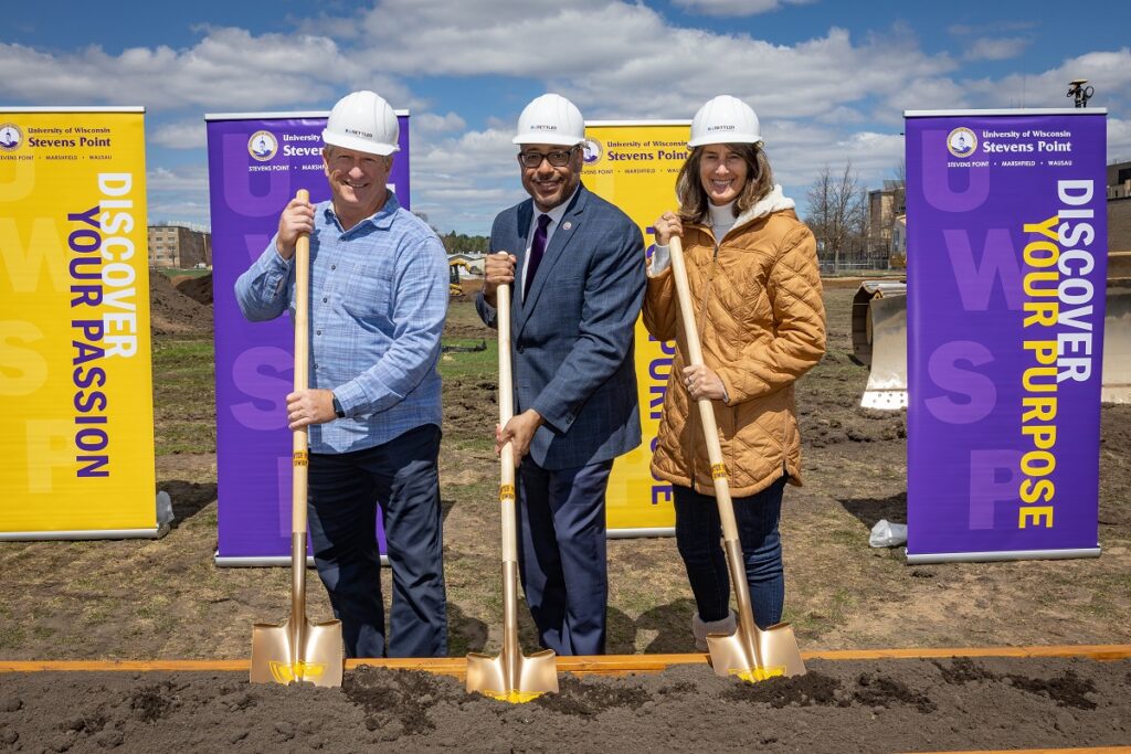 Photo of turf project groundbreaking: alumni Breck (left) and Sheri Loos provided a significant gift to support developing a multipurpose sports complex at UW-Stevens Point. They are with Chancellor Thomas Gibson as work begins on the north side of campus.