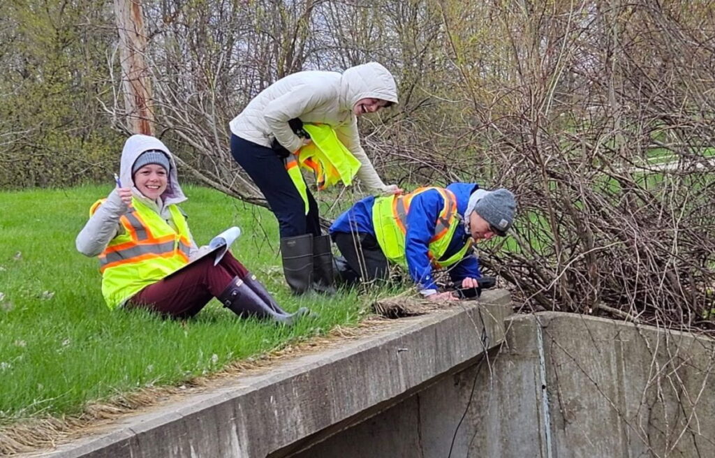 Photo of students collecting water data: Data collected by high school students contributes to long-term monitoring of the Fox Valley watershed. (Photo courtesy of Freshwater Collaborative of Wisconsin)