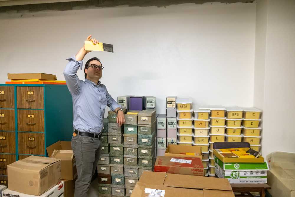 Photo of David Mindel, digital collections librarian at UWL, looking over some of the steamboat materials recently donated to Special Collections. “With all of the recent donations, UW-La Crosse’s designation as one of the top centers for steamboat materials is solidified even more,” says Mindel.