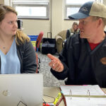 Photo of Humane Handling Institute Program Manager Ashlynn Kirk listening to Brandon Clare, owner of JM Watkins meat processing plant in Plum City, as they discuss details of ensuring compliance with federal regulations. Kirk helped Clare individualize a humane handling plan for his plant. UWRF photo.