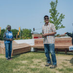 Photo of Mabel Lamb, executive director of Sherman Park Community Organization, and Steve O’Connell, a Sherman Park neighbor and member of Sherman Park ECO, preparing to cut the ribbon at the grand opening of Postage Stamp Park. (Photo courtesy of MPS/Alvin Connor)