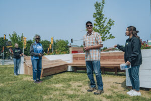 Photo of Mabel Lamb, executive director of Sherman Park Community Organization, and Steve O’Connell, a Sherman Park neighbor and member of Sherman Park ECO, preparing to cut the ribbon at the grand opening of Postage Stamp Park. (Photo courtesy of MPS/Alvin Connor)