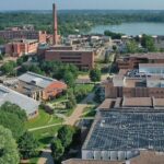 Photo of an aerial view of south campus academic buildings, displaying the Jarvis Hall Tech Wing solar panel array, lower right / UW-Stout