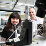 Photo of Naomi Raicu working with Ionel Popa, associate professor of physics, studying misfolding proteins. Those misfolding proteins can lead to Alzheimer’s and other conditions. (UWM Photo/Troye Fox)
