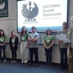 Photo of the Stream Team presenting their water quality research to community members.