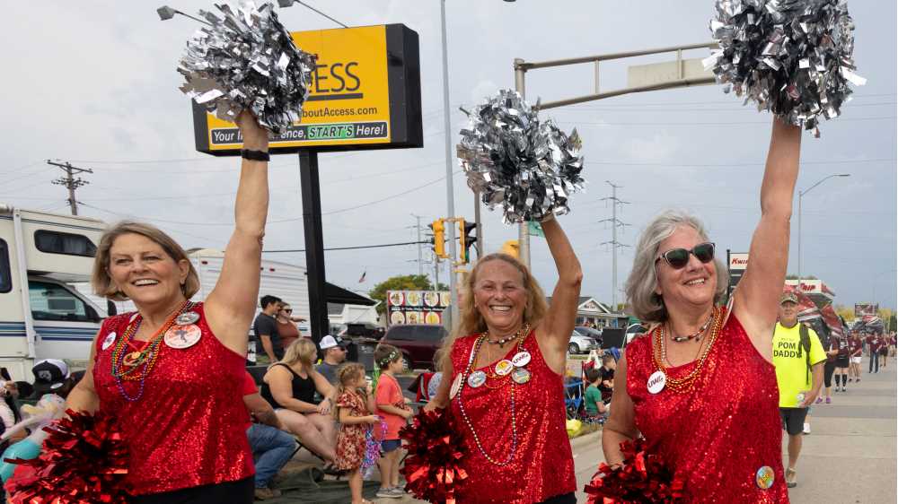 Photo of members of the 1973-74 UWL PomPons who marched in the La Crosse Oktoberfest parade this September — 50 years after their memorable appearance at the Orange Bowl in Miami. (Jen Towner, UWL University Marketing & Communications)