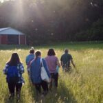 Photo of students from UW-Stout’s LAKES summer research program visiting a Dunn County Farm. / UW-Stout