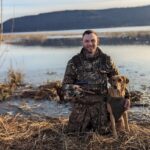 Photo of Cody Kamrowski, UW-Stevens Point '16, with his dog, Nova, working to preserve outdoor habitats.